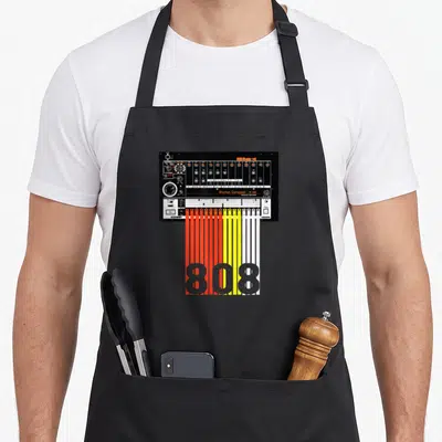 Drum machine apron - Black drum machine with red yellow white cables forming 808 text — shown on a black cotton canvas apron against a white background
