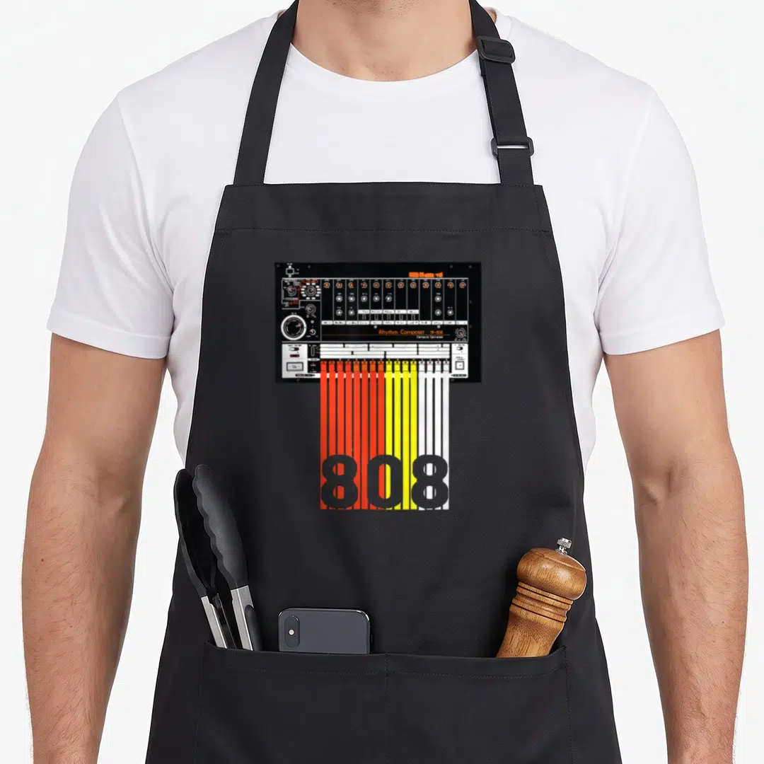 Drum machine apron - Black drum machine with red yellow white cables forming 808 text — shown on a black cotton canvas apron against a white background
