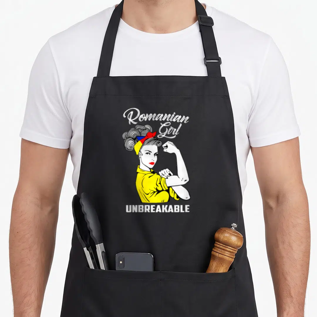 Heritage romanian apron - Cartoon woman flexing arm wearing yellow shirt and tri-color headband with Romanian Girl — shown on a black cotton canvas apron against a white background