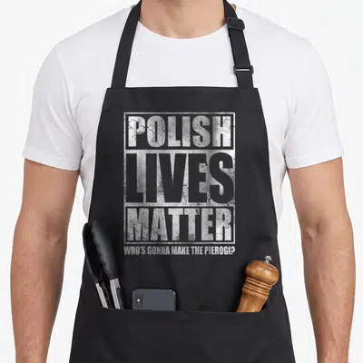 Live polish aprons - Distressed white and grey typography reading POLISH LIVES MATTER WHO'S GONNA MAKE THE PIEROGI? — shown on a black cotton canvas apron against a white background