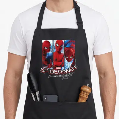 Three web3 apron - Spider-Man three vertical panels red blue white Homecoming text web — shown on a black cotton canvas apron against a white background