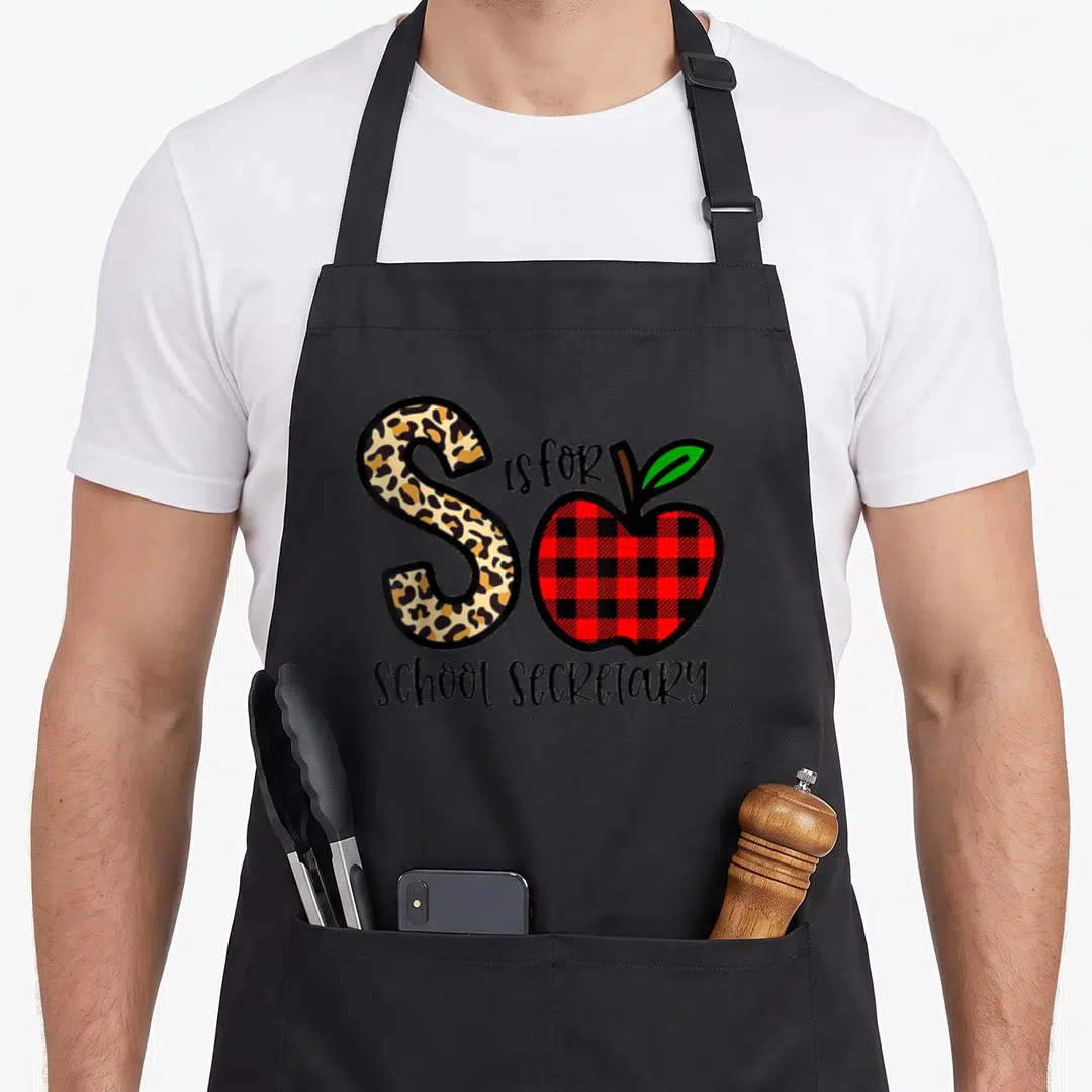 School plain red apron - Leopard print letter S and red plaid apple with School Secretary text — shown on a black cotton canvas apron against a white background