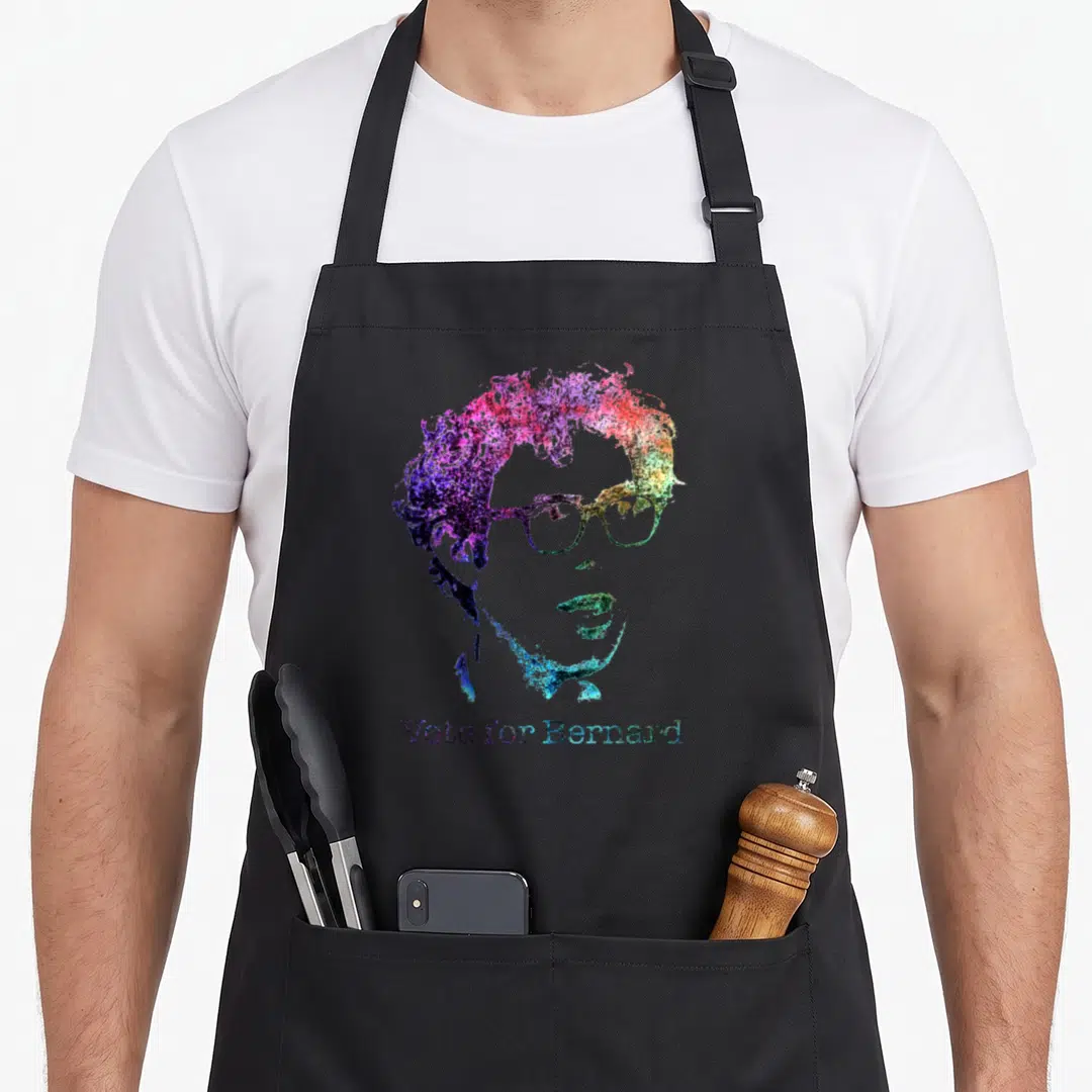 Bernie rainbow apron - Watercolor portrait of a man with glasses and text Vote for Bernard in rainbow colors — shown on a black cotton canvas apron against a white background