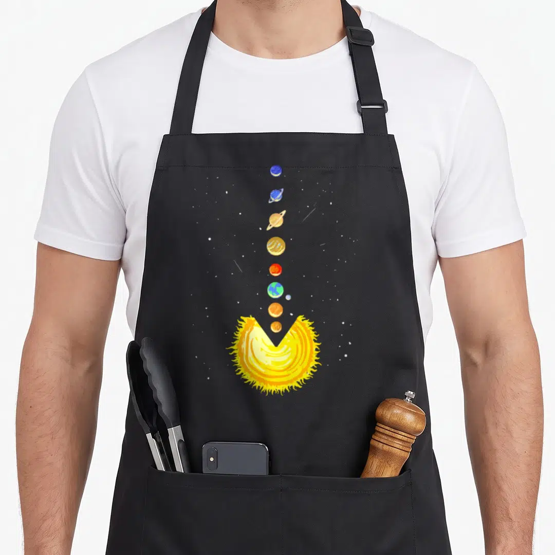 Astronomer zodiac aprons - Cartoon solar system with eight planets ascending from a yellow sun with a V-cutout — shown on a black cotton canvas apron against a white background