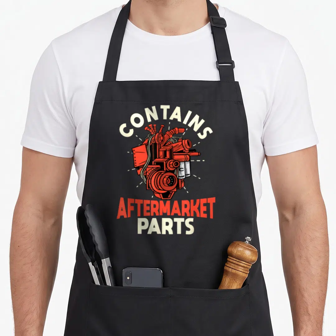 Contain open apron - Red mechanical heart illustration with arched white and stacked red text reading CONTAINS — shown on a black cotton canvas apron against a white background