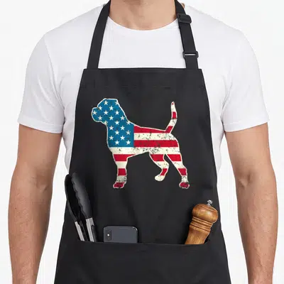 Bulldog dog 4th of july apron - Distressed American flag pattern filling a standing dog silhouette in red, white — shown on a black cotton canvas apron against a white background
