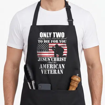 Died veterans apron - Distressed flag soldier silhouette with Only Two Defining Forces text — shown on a black cotton canvas apron against a white background