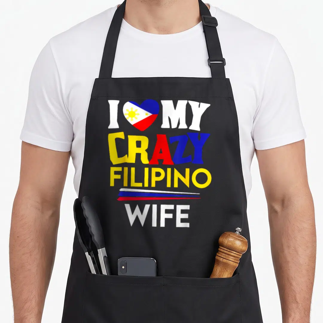 Philippine wife apron - I heart my crazy Filipino wife text with red blue yellow and white typography — shown on a black cotton canvas apron against a white background