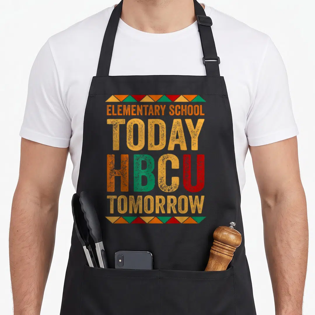 Future college grad apron - Stacked text ELEMENTARY SCHOOL TODAY HBCU TOMORROW with orange green red triangle borders — shown on a black cotton canvas apron against a white background