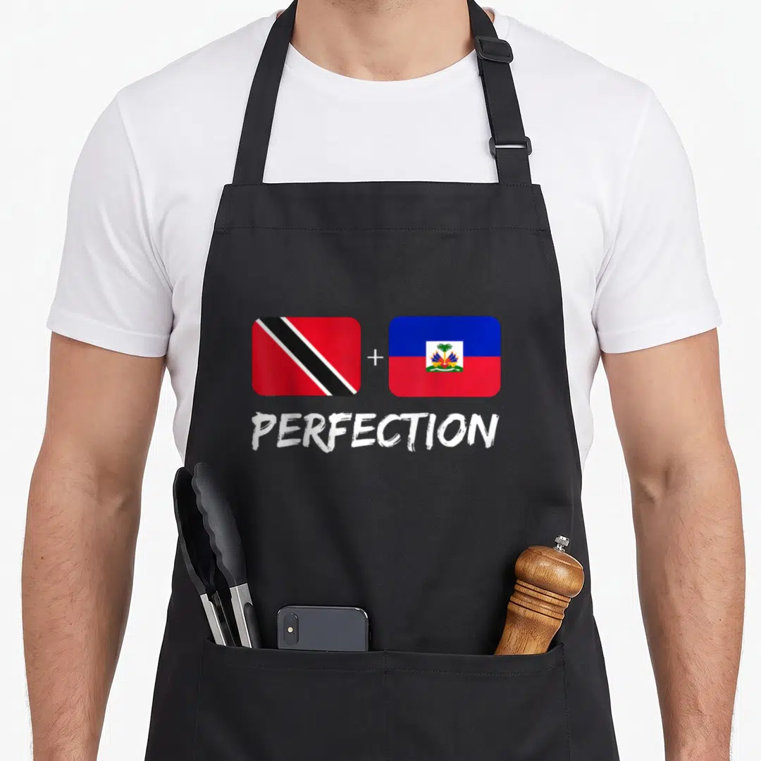 Trinidadian haitian heritage aprons - Two flags with plus sign and PERFECTION text below — shown on a black cotton canvas apron against a white background