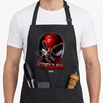 Infinity face apron - Realistic Spider-Man in red and blue suit with gold mechanical arms and SPIDER-MAN text below — shown on a black cotton canvas apron against a white background