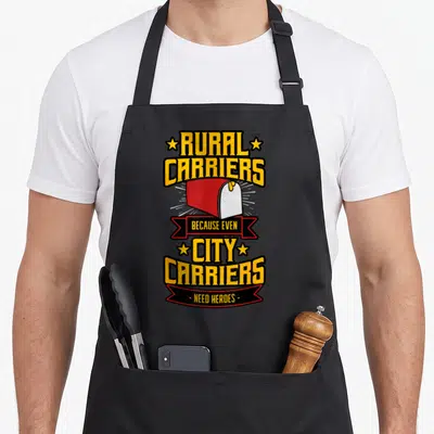 Delivery postal aprons - Red mailbox with yellow Rural Carriers Because Even City Carriers Need Heroes text — shown on a black cotton canvas apron against a white background