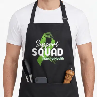 Support lime green apron - Green awareness ribbon with Support SQUAD #MentalHealth text in white and green — shown on a black cotton canvas apron against a white background