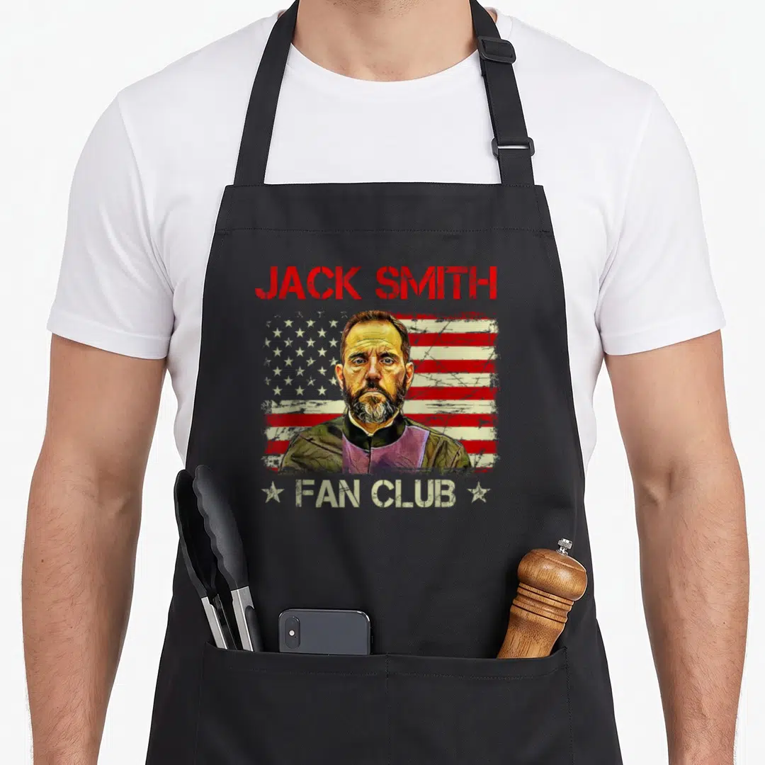Jack american flag apron - Distressed USA flag behind man portrait with Jack Smith Fan Club text and white stars — shown on a black cotton canvas apron against a white background