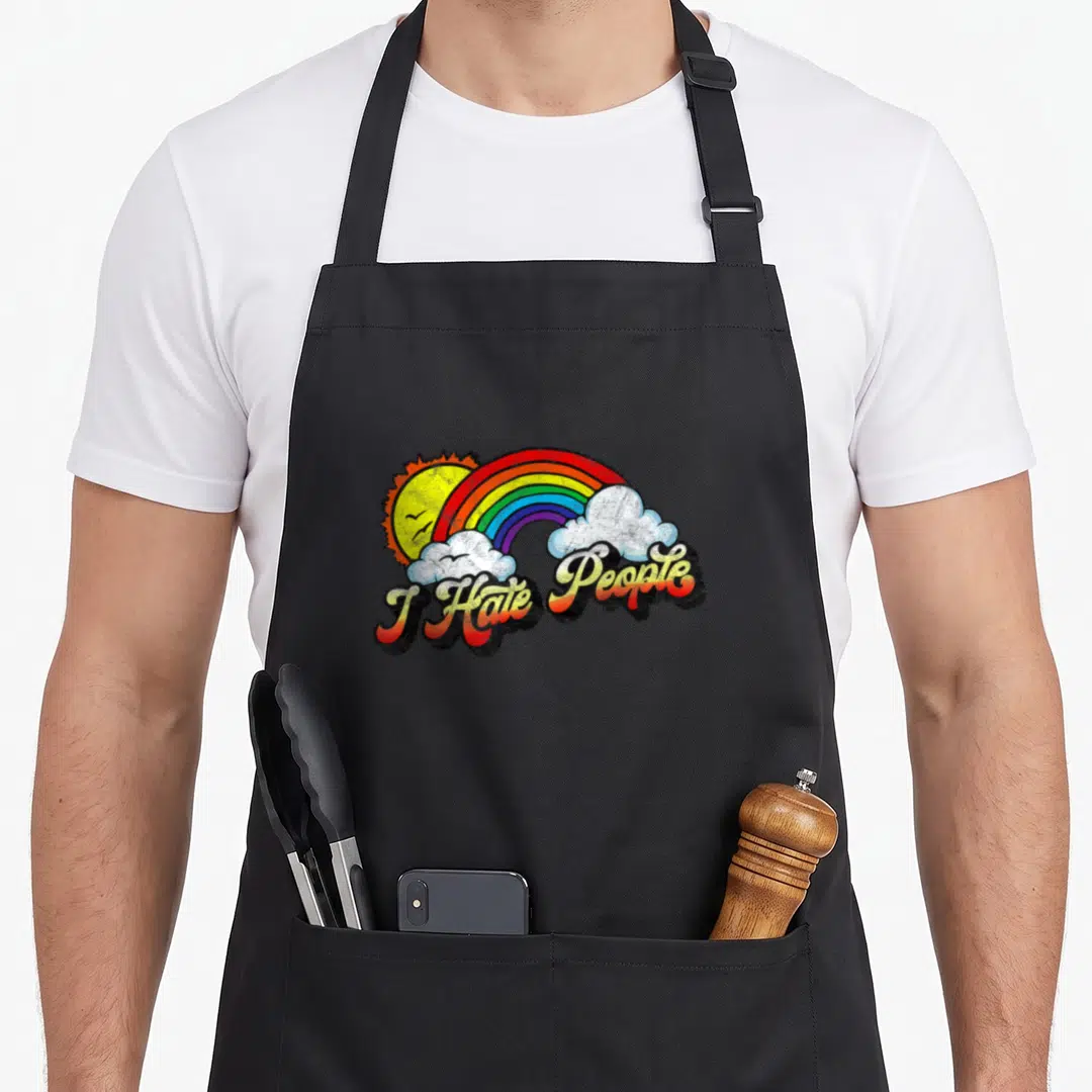 Hate rainbow apron - I Hate People text under rainbow sun and clouds cartoon art — shown on a black cotton canvas apron against a white background