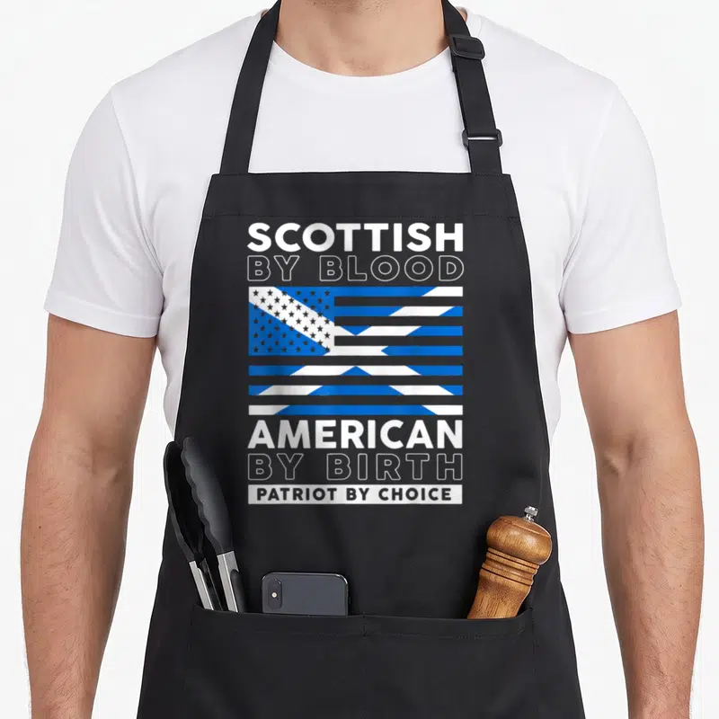 Choice blood apron - SCOTTISH BY BLOOD AMERICAN BY BIRTH PATRIOT BY CHOICE text with blue white flag graphic — shown on a black cotton canvas apron against a white background