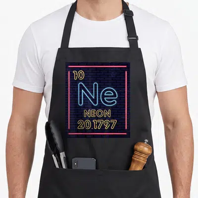 Neon element table apron - Neon element symbol Ne 10 20.1797 in red border on brick background — shown on a black cotton canvas apron against a white background