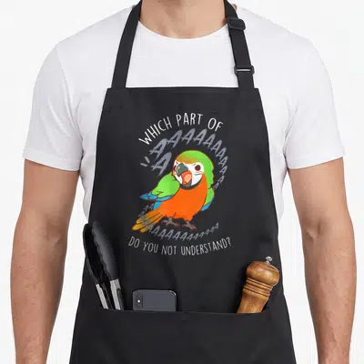 Catalina bird apron - Cartoon parrot screaming with text which part of aaaaaaa do you not understand — shown on a black cotton canvas apron against a white background