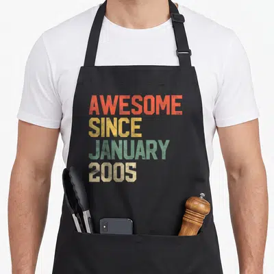 17th january birthday apron - Stacked AWESOME SINCE JANUARY 2005 text in orange yellow green beige block letters — shown on a black cotton canvas apron against a white background