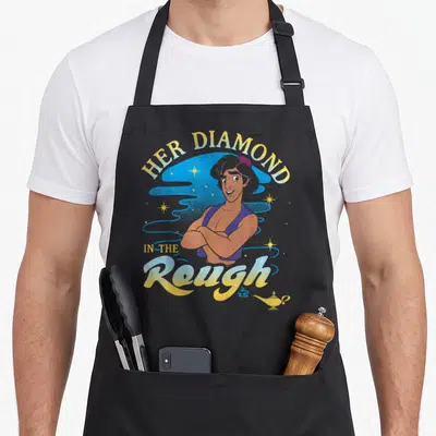 Diamond girl birthday apron - Aladdin crossed arms Her Diamond in the Rough text blue cloud magic lamp — shown on a black cotton canvas apron against a white background
