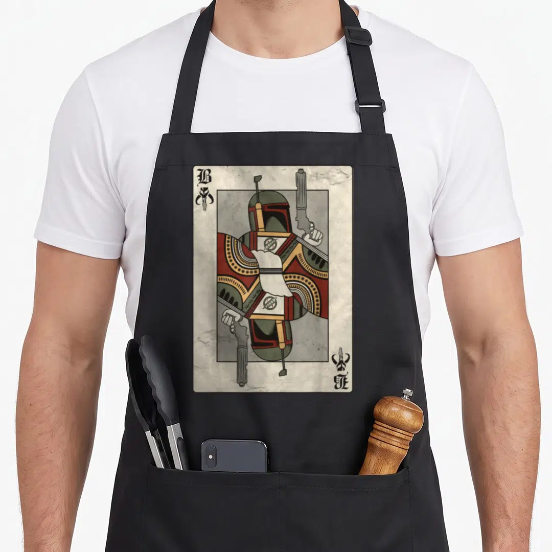 Bounty hunter apron - Mirrored Boba Fett playing card with B and skull symbols in green and red — shown on a black cotton canvas apron against a white background