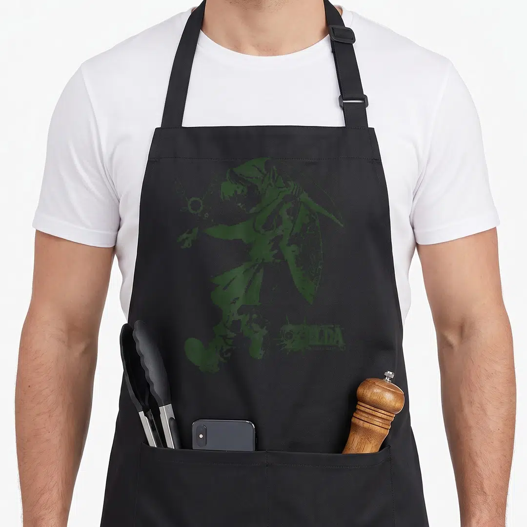 Majoras line apron - Dark green line art of Link reaching for Navi with game logo — shown on a black cotton canvas apron against a white background