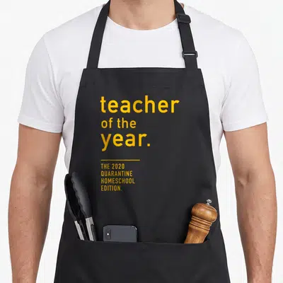 Quarantine teacher apron - Yellow stacked text reading teacher of the year 2020 quarantine homeschool edition — shown on a black cotton canvas apron against a white background