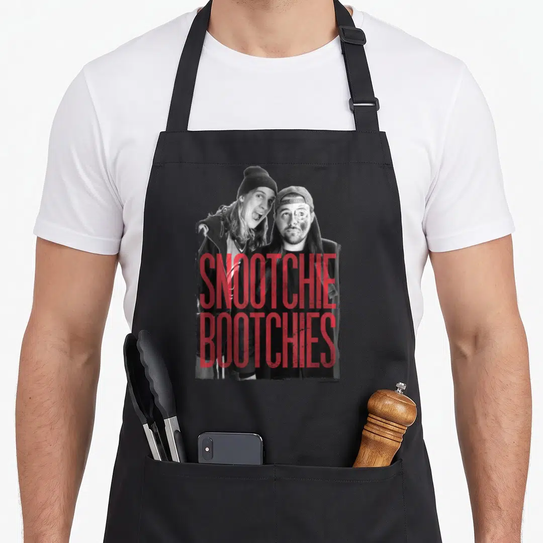Snootchie jay silent bob apron - Red SNOOTCHIE BOOTCHIES text over black and white photo of two men wearing beanies — shown on a black cotton canvas apron against a white background