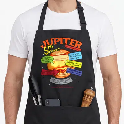 Learning teaching apron - Cartoon Jupiter planet with colorful speech bubbles listing facts about moons, rings — shown on a black cotton canvas apron against a white background