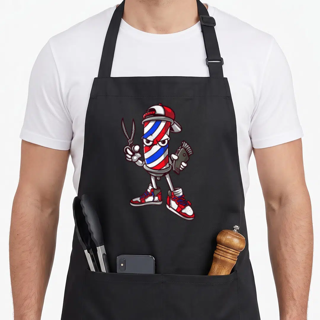 Outfit barbershop aprons - Cartoon barber pole character with red white blue stripes holding scissors and clippers — shown on a black cotton canvas apron against a white background