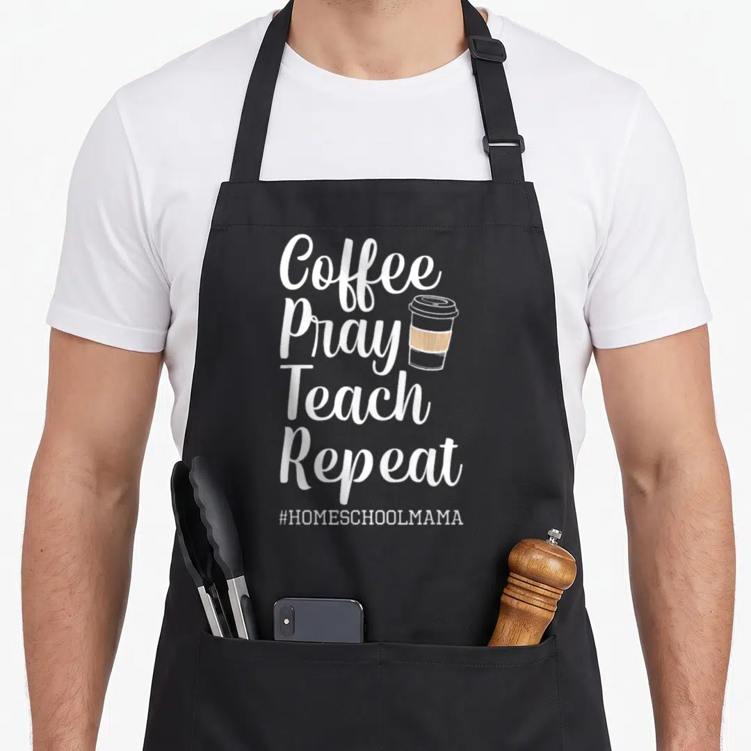 Pray coffee apron - Stacked white text Coffee Pray Teach Repeat next to a brown and grey coffee cup — shown on a black cotton canvas apron against a white background