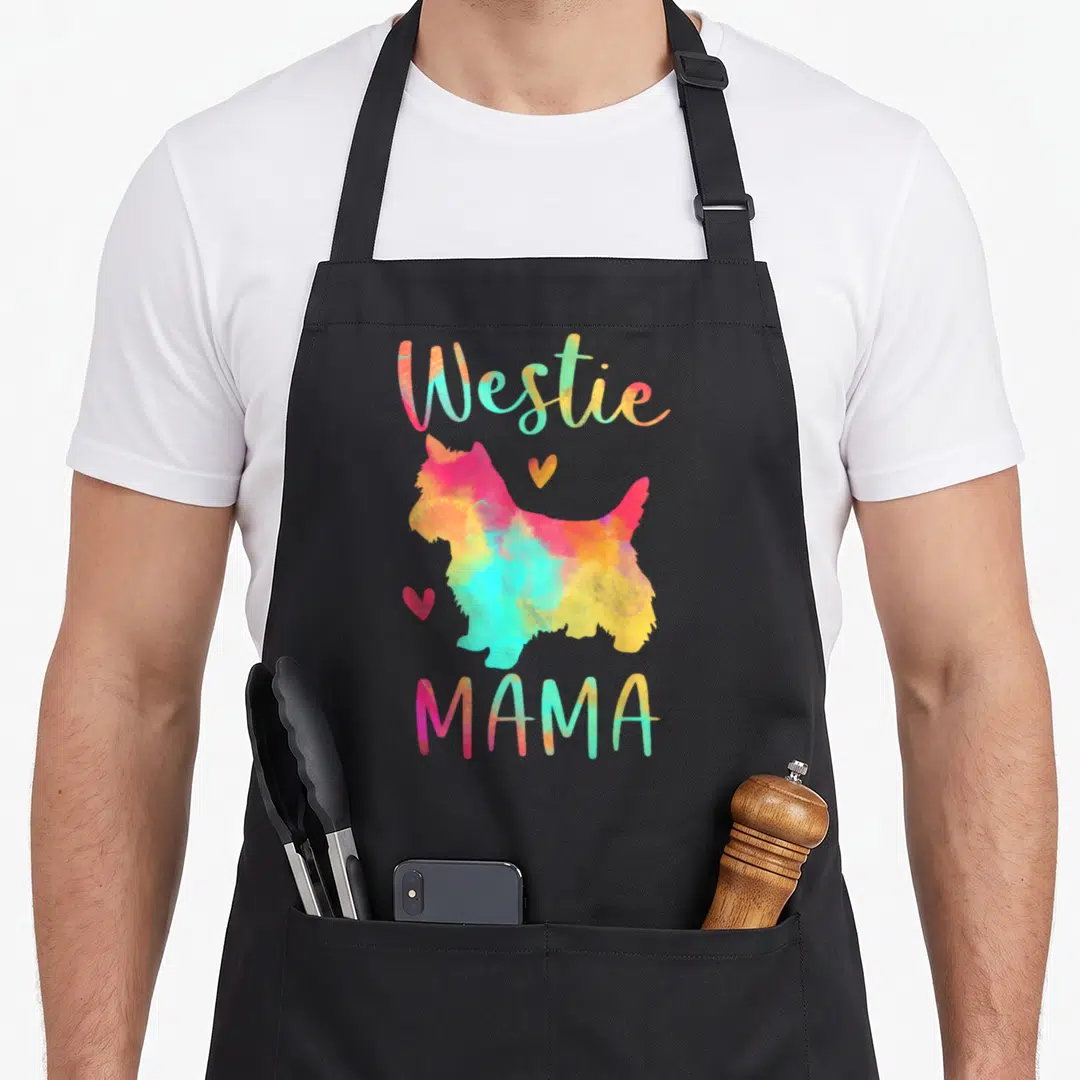 Colorful westie apron - Watercolor Westie silhouette in pink yellow blue orange with two hearts and Westie MAMA text — shown on a black cotton canvas apron against a white background