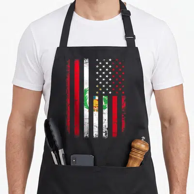 Peruvian american flag apron - Distressed composite flag with red white blue green stripes and central emblem featuring — shown on a black cotton canvas apron against a white background