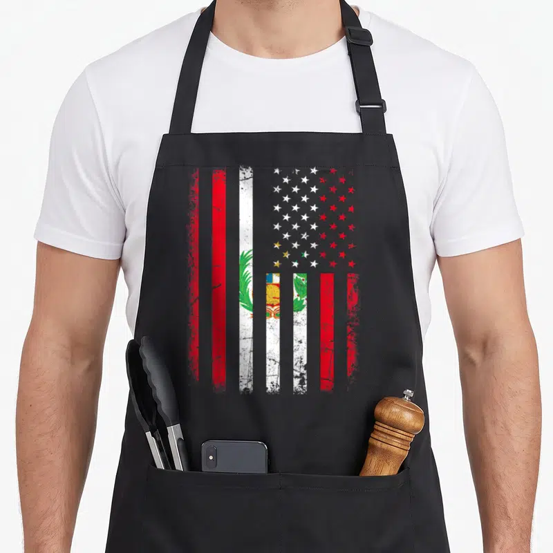 Peruvian american flag apron - Distressed composite flag with red white blue green stripes and central emblem featuring — shown on a black cotton canvas apron against a white background