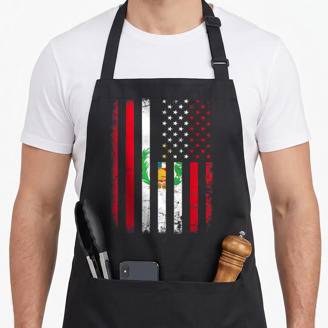 Peruvian american flag apron - Distressed composite flag with red white blue green stripes and central emblem featuring — shown on a black cotton canvas apron against a white background