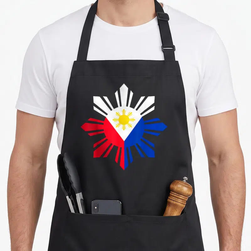 Philippine filipino apron - Minimalist Philippine flag sun in yellow white red and blue with two front pockets — shown on a black cotton canvas apron against a white background