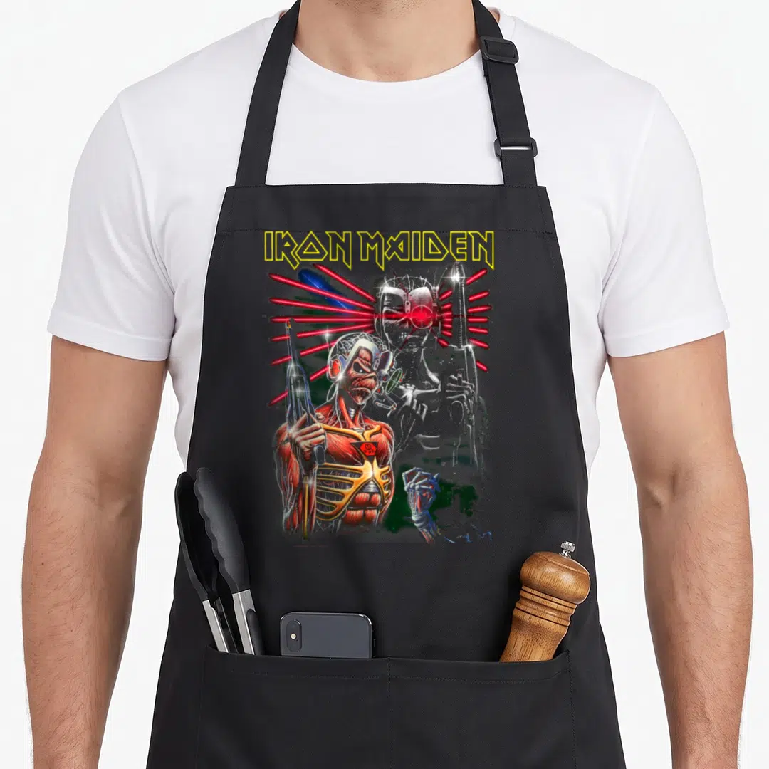 Terminate collection apron - Zombie cyborg with red lasers and IRON MAIDEN text on grey background — shown on a black cotton canvas apron against a white background