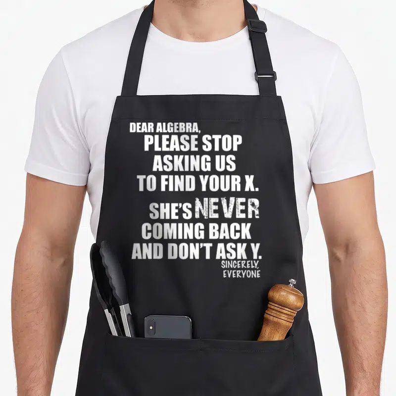 Dear algebra us aprons - White stacked text reading Dear Algebra please stop asking us to find your X on black — shown on a black cotton canvas apron against a white background