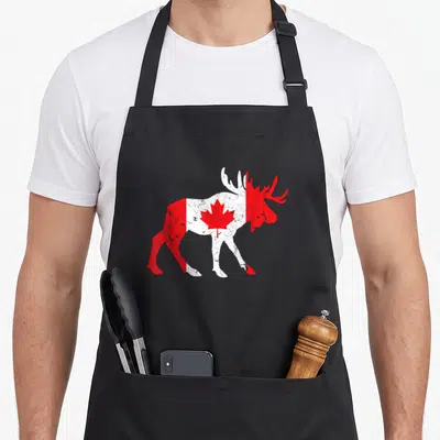 Maple animal apron - Distressed red and white moose silhouette containing a central maple leaf — shown on a black cotton canvas apron against a white background