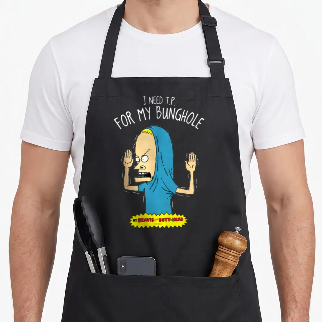 Beavis judge humor apron - Beavis cartoon with I Need T.P. For My Bunghole text and yellow show logo banner — shown on a black cotton canvas apron against a white background