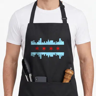 Skyline pride chicago apron - Mirrored light blue skyline with four red stars in center band — shown on a black cotton canvas apron against a white background