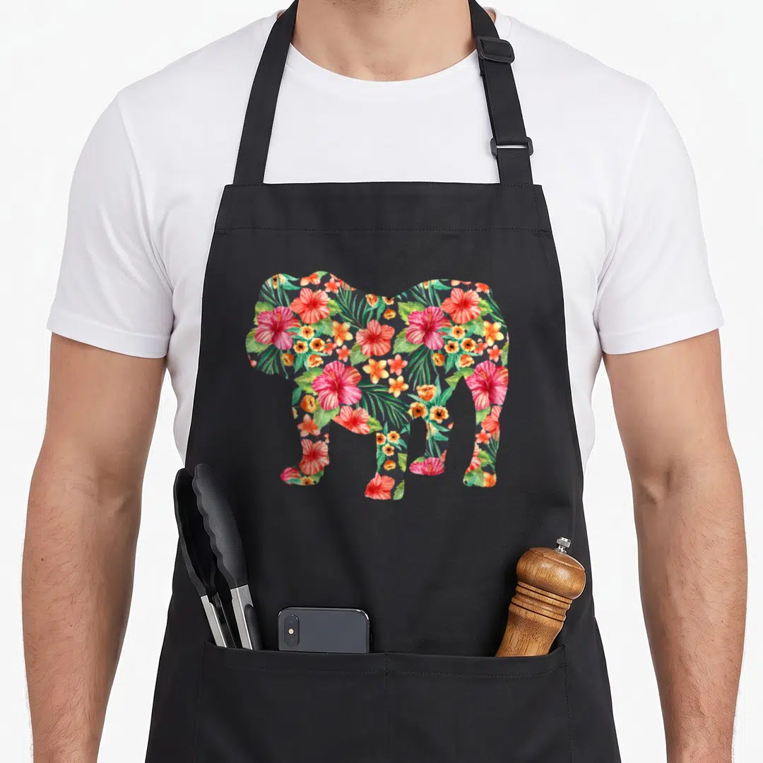 Silhouette english chef aprons - Elephant silhouette filled with red pink green and orange tropical flowers — shown on a black cotton canvas apron against a white background
