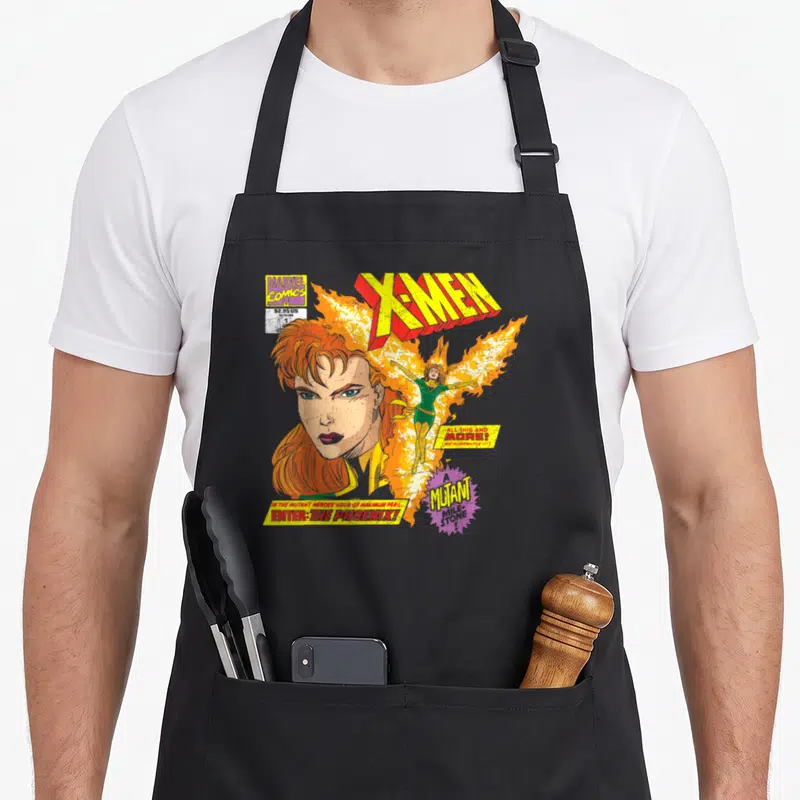 Mutant jean apron - Jean Grey portrait Phoenix fire X-Men comic text Mutant Milk Store retro art — shown on a black cotton canvas apron against a white background