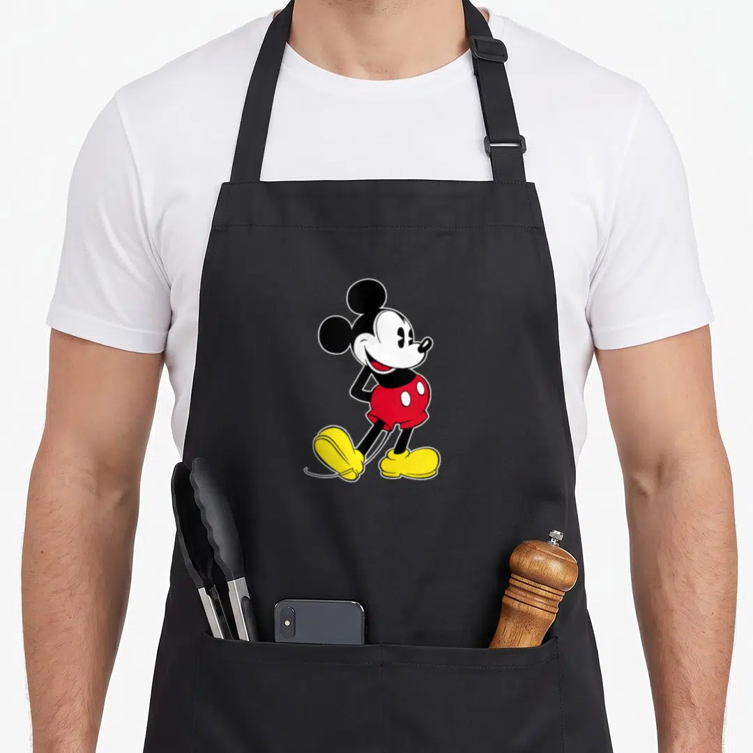 Funny pose mouse apron - Centered cartoon mouse in black red and yellow pose — shown on a black cotton canvas apron against a white background