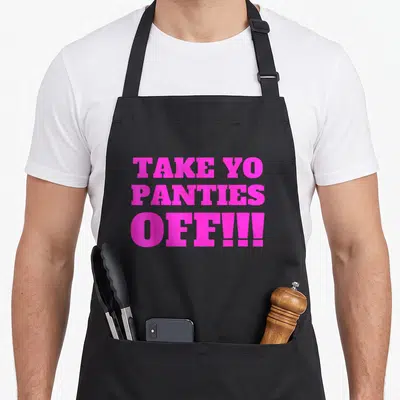 Panty theme aprons - Pink stacked text reading TAKE YO PANTIES OFF!!! in bold block letters — shown on a black cotton canvas apron against a white background