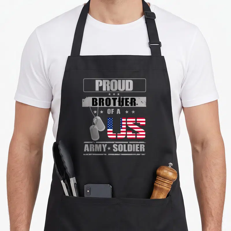 Brother us aprons - Stacked text PROUD BROTHER OF A US ARMY SOLDIER with flag US and two dog tags — shown on a black cotton canvas apron against a white background