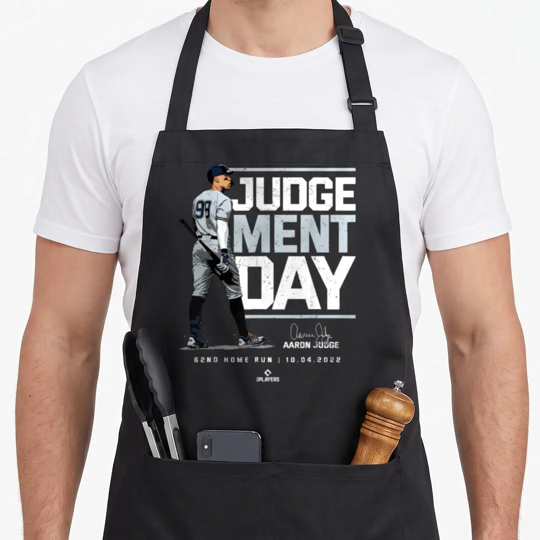 Judgement new york apron - Aaron Judge illustration with JUDGE MENT DAY text and 62nd home run date — shown on a black cotton canvas apron against a white background