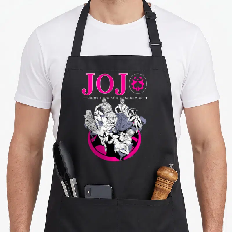 Part golden apron - Five men in line-art around a table below large pink JOJO text and emblem on pink circle background — shown on a black cotton canvas apron against a white background