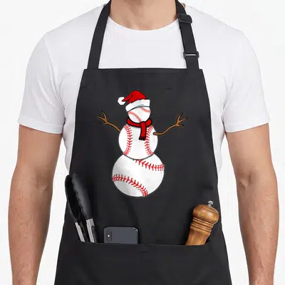 Christmas snowman apron - Snowman made of three baseballs with red stitching, Santa hat, red scarf, and brown branch — shown on a black cotton canvas apron against a white background