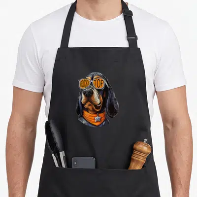 Tennessee dog apron - Realistic coonhound head with rocky top sunglasses and orange bandana silver star — shown on a black cotton canvas apron against a white background